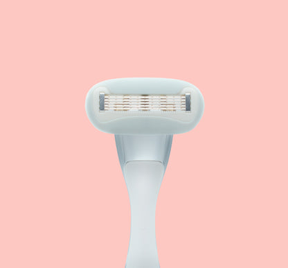 Underside of razor blade cartridge on pink background