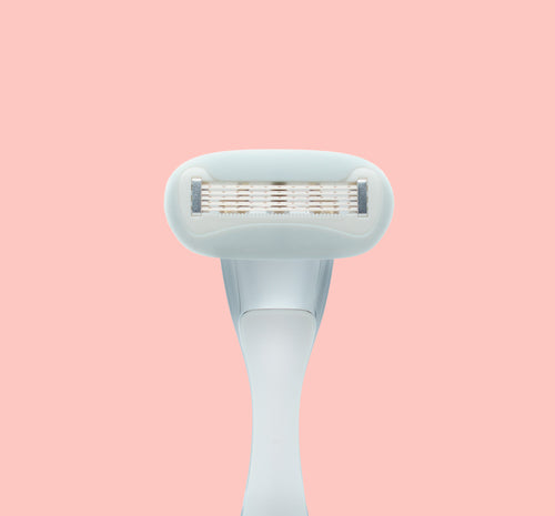 Underside of razor blade cartridge on pink background